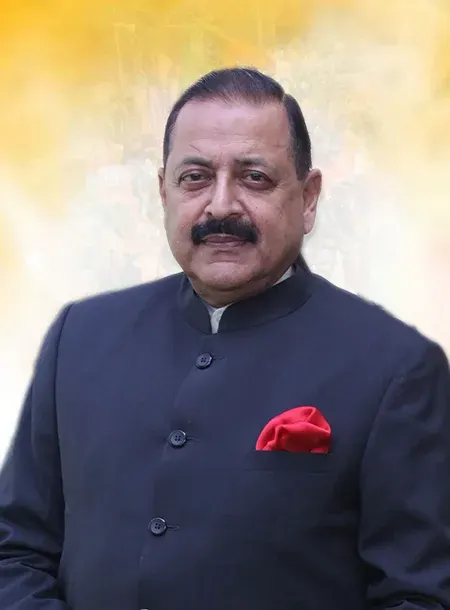 Formal portrait of Dr. Jitendra Singh in a dark bandhgala jacket with a red pocket square