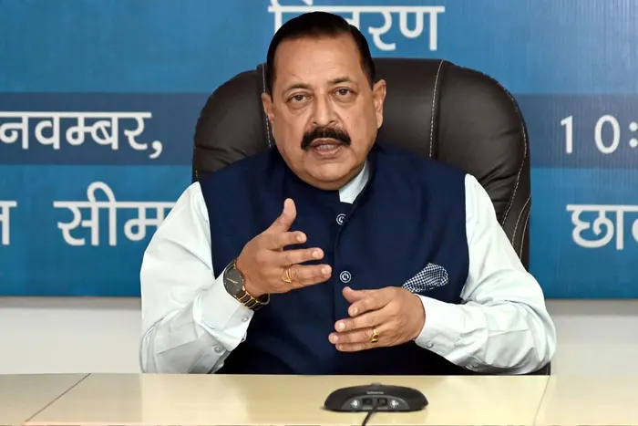 Dr. Jitendra Singh seated at a table with a conference microphone