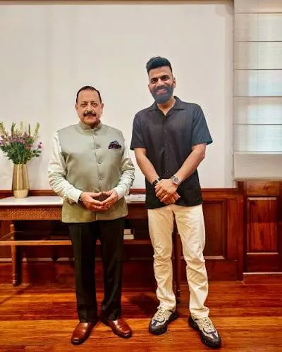 Dr. Jitendra Singh standing in an office beside a visitor